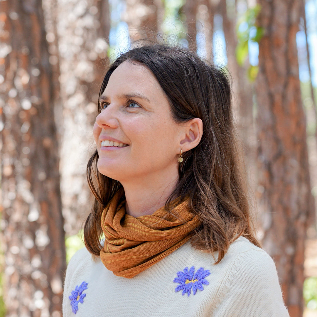 Woman standing in a forest with trees in the background
